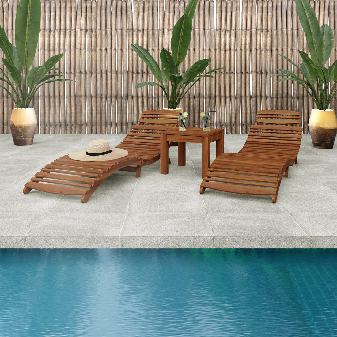 Wave Hardwood Acacia Outdoor Sun Loungers Set of 2 in Natural, featuring curved designs on a tiled deck with a side table, iced drinks, a straw hat, and tropical plants in the backdrop.