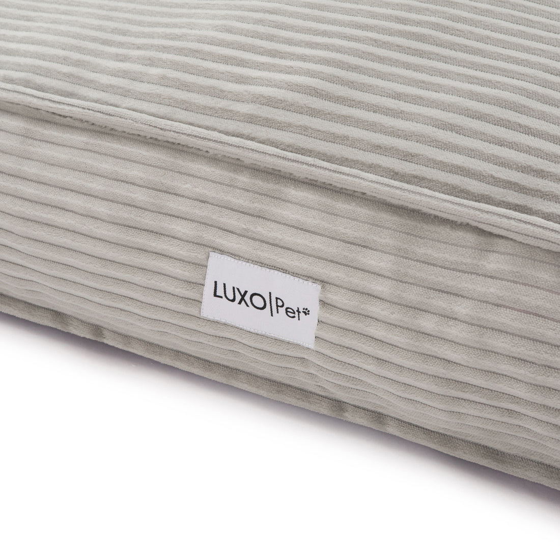 Close-up of the Dax Medium Corduroy Dog Bed – Grey Soft Support, showcasing its plush fibre filling, raised bolstered edges, and corduroy texture for pet comfort and modern home style.
