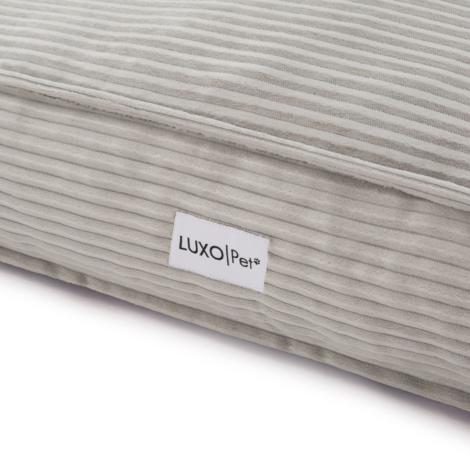 Close-up of the Dax Medium Corduroy Dog Bed – Grey Soft Support, showcasing its plush fibre filling, raised bolstered edges, and corduroy texture for pet comfort and modern home style.