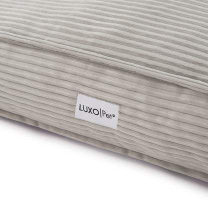 Close-up of the Dax Medium Corduroy Dog Bed – Grey Soft Support, showcasing its plush fibre filling, raised bolstered edges, and corduroy texture for pet comfort and modern home style.