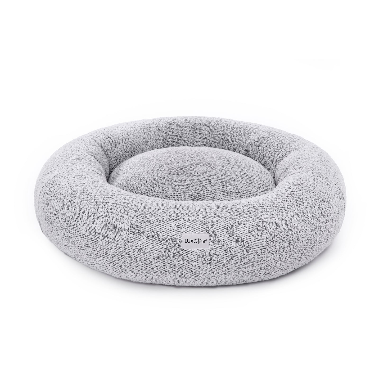 Kyra Large Boucle Pet Bed – White with Black Base, featuring a curved bolster design for neck support, soft boucle fabric, and a modern aesthetic suitable for large dogs.