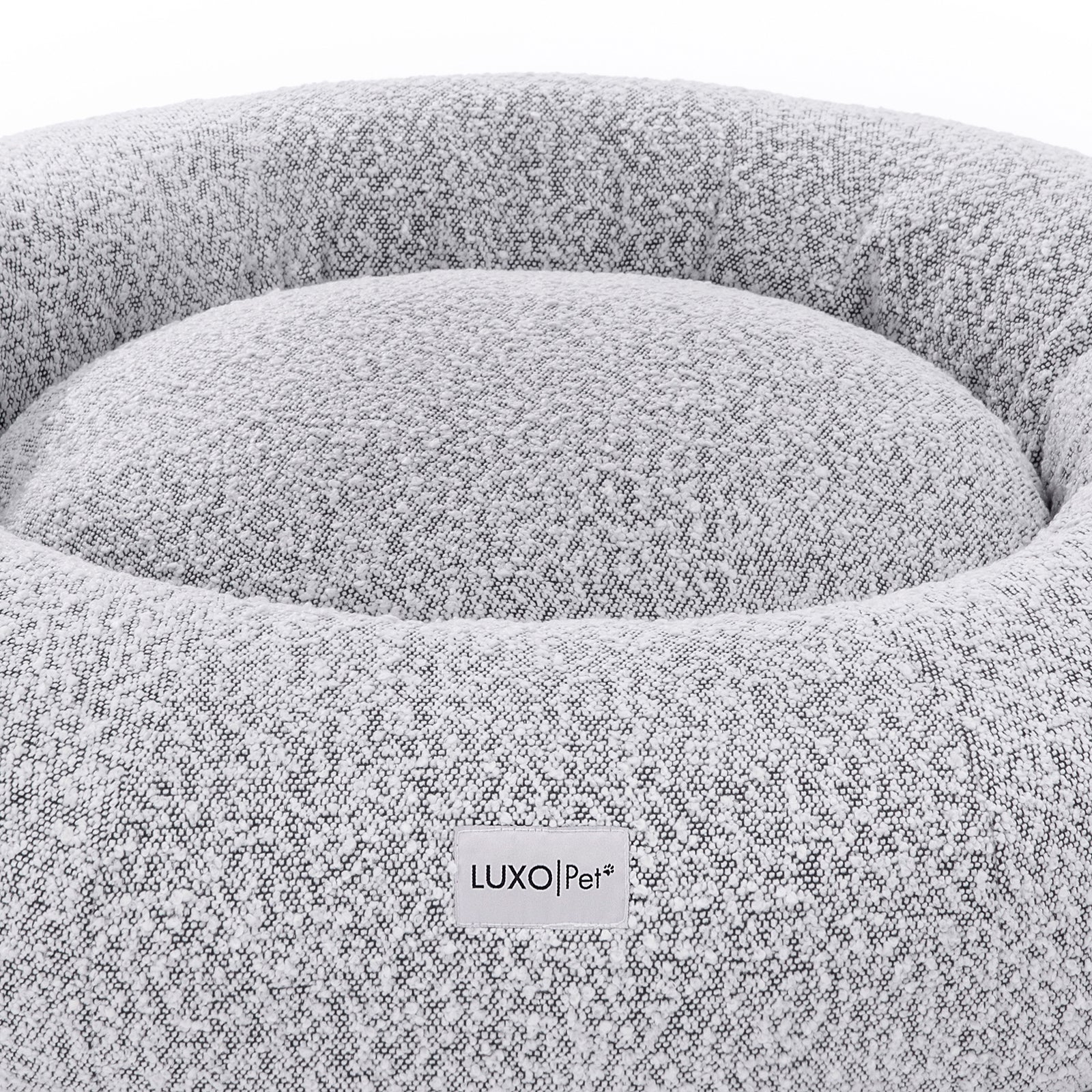 Kyra Large Boucle Pet Bed – White with Black Base: Close-up of a plush, supportive pet bed featuring raised bolster edges and non-slip base, crafted from soft boucle fabric for stylish pet comfort.