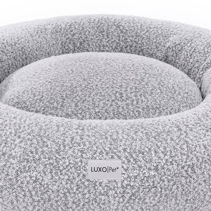 Kyra Large Boucle Pet Bed – White with Black Base: Close-up of a plush, supportive pet bed featuring raised bolster edges and non-slip base, crafted from soft boucle fabric for stylish pet comfort.