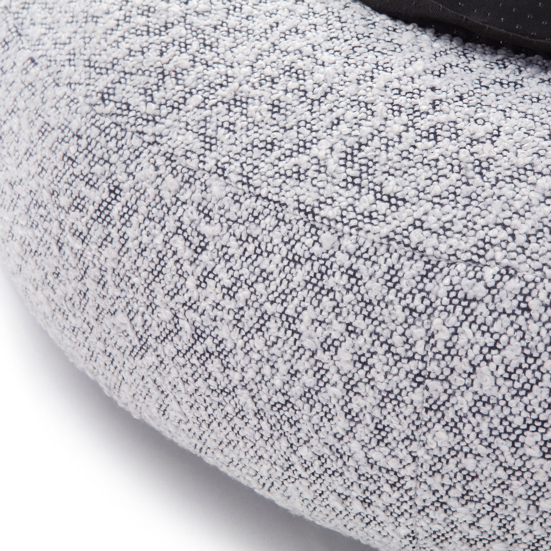 Kyra Large Boucle Pet Bed features soft boucle fabric with raised bolster edges for support, a sleek white design with a contrasting black base, and a non-slip foundation for stability.