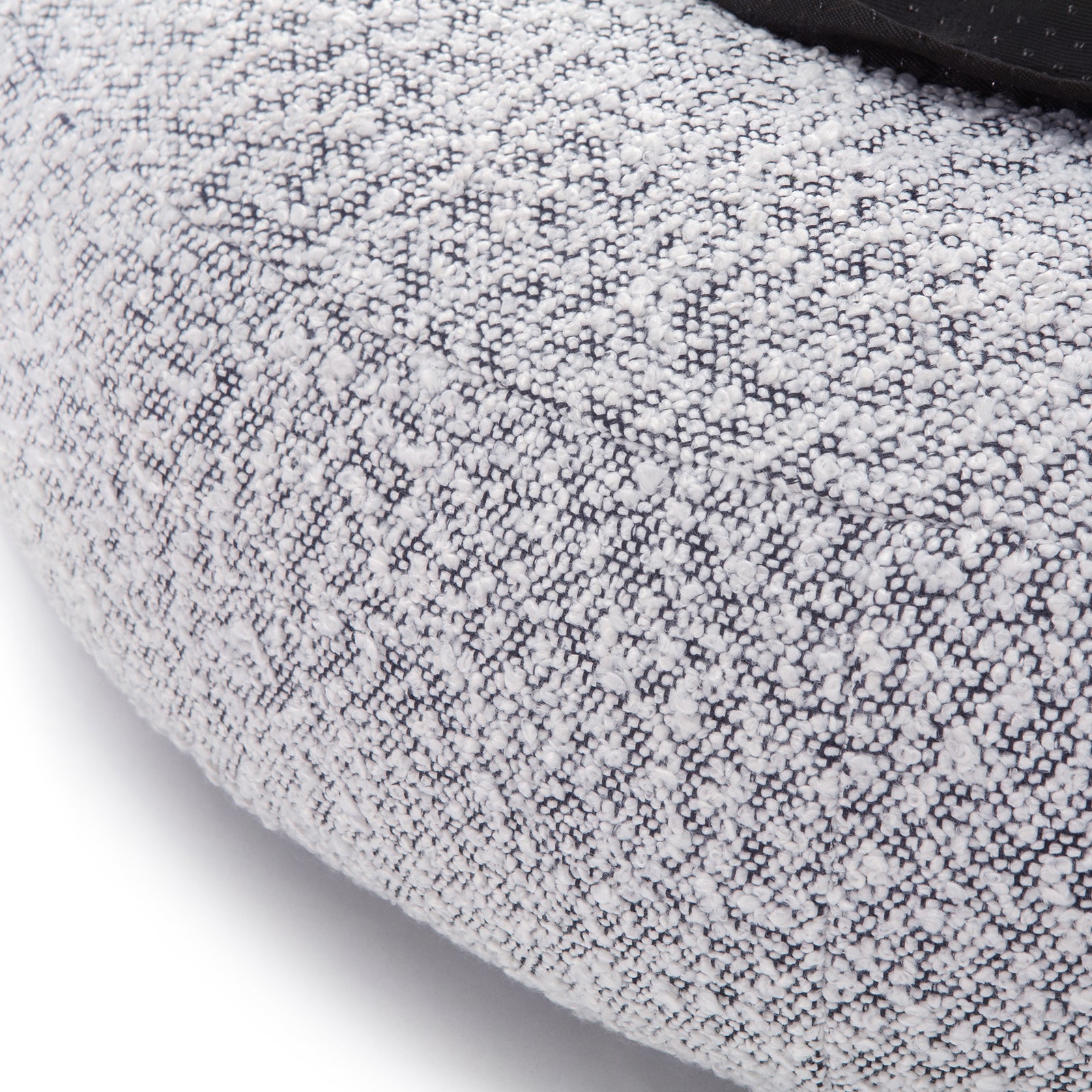 Kyra Large Boucle Pet Bed features soft boucle fabric with raised bolster edges for support, a sleek white design with a contrasting black base, and a non-slip foundation for stability.