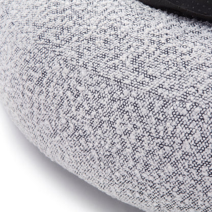 Kyra Large Boucle Pet Bed features soft boucle fabric with raised bolster edges for support, a sleek white design with a contrasting black base, and a non-slip foundation for stability.