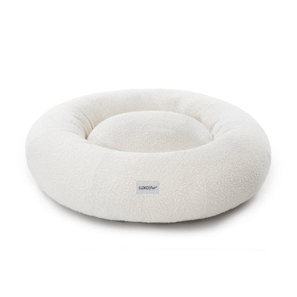 Kyra Large Boucle Pet Bed – Light Beige Plush Comfort features plush raised bolsters, boucle fabric, and a sculpted design, ideal for large pets seeking ergonomic support and a stylish nap space.