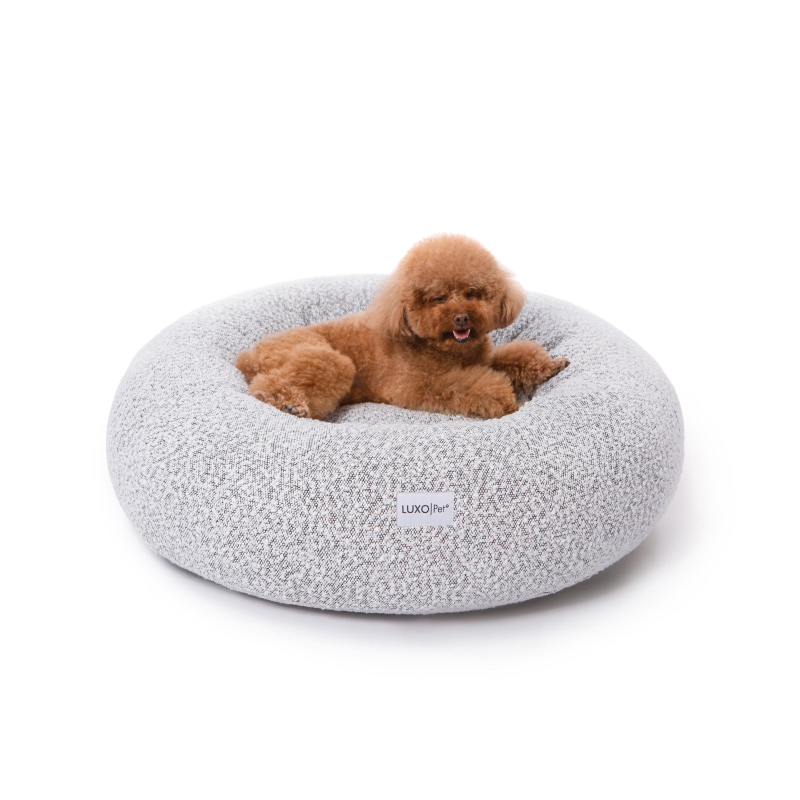 Close-up of the Kyra Medium Boucle Pet Bed – White with Black Base, featuring plush raised bolsters and a luxurious white boucle texture, offering ergonomic support for pets.