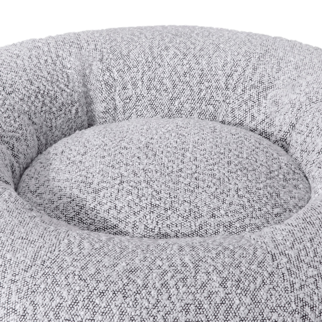 Kyra Medium Boucle Pet Bed – White with Black Base features soft curves, raised bolsters, and a plush white texture, offering ergonomic comfort and modern style with a non-slip black base for stability.