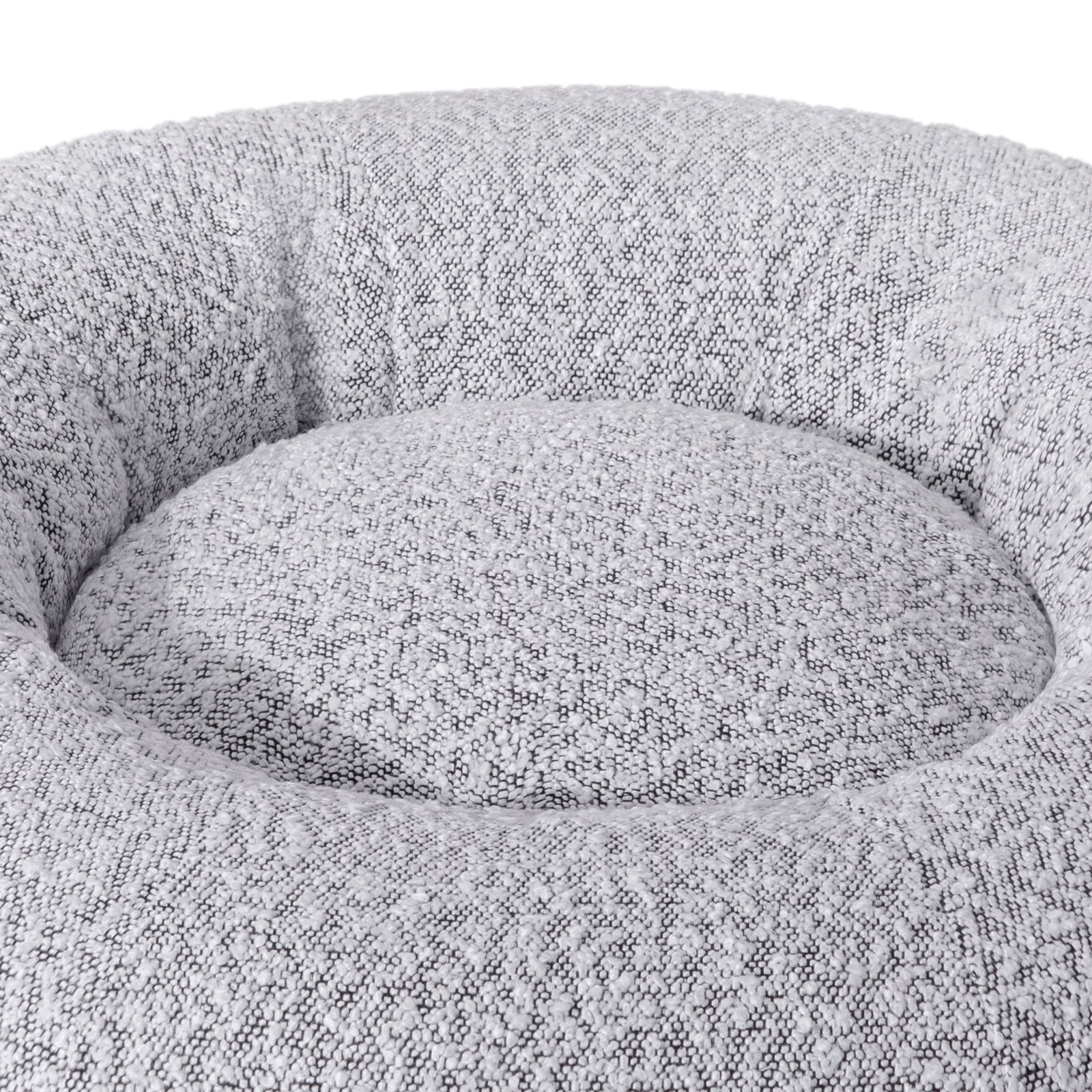Kyra Medium Boucle Pet Bed – White with Black Base features soft curves, raised bolsters, and a plush white texture, offering ergonomic comfort and modern style with a non-slip black base for stability.