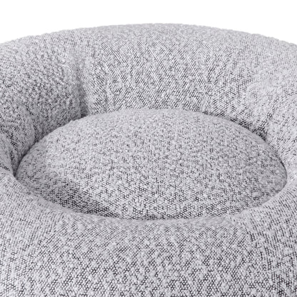 Kyra Medium Boucle Pet Bed – White with Black Base features soft curves, raised bolsters, and a plush white texture, offering ergonomic comfort and modern style with a non-slip black base for stability.