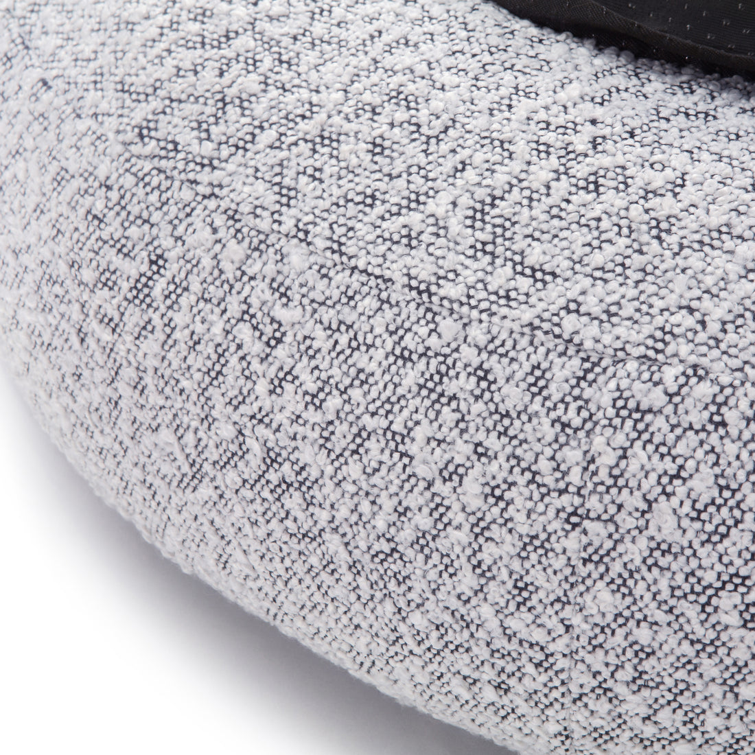 Kyra Medium Boucle Pet Bed – White with Black Base showcasing close-up of textured boucle fabric with visible stitches, highlighting plush support and ergonomic raised bolsters for pet comfort.