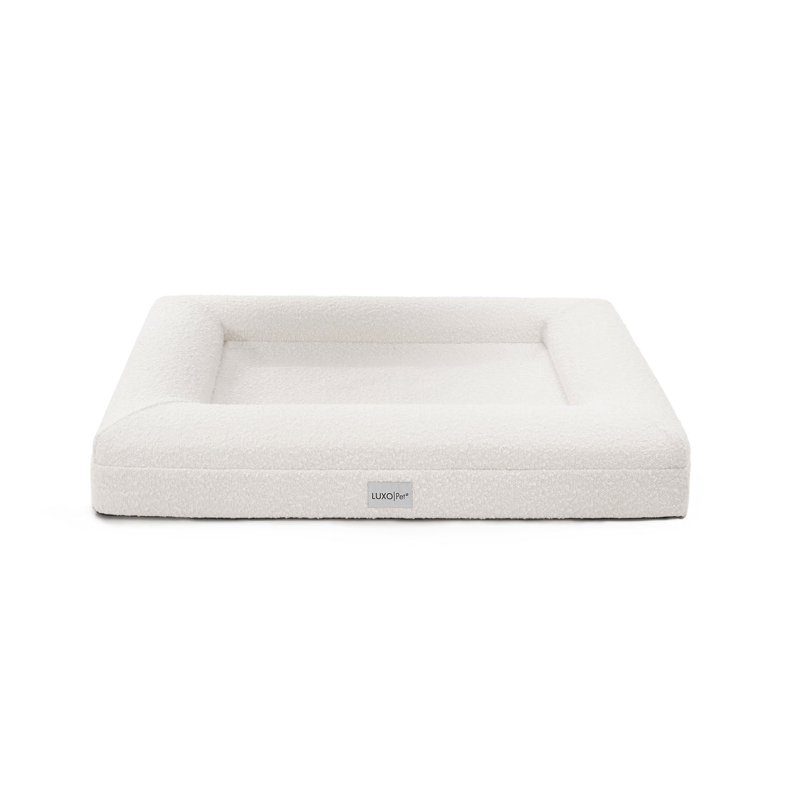 Tyro Luxe Medium Orthopedic Pet Bed – Light Beige features a dual-layer orthopedic foam core with soft boucle fabric, highlighted by a subtle logo, designed for joint support and style.