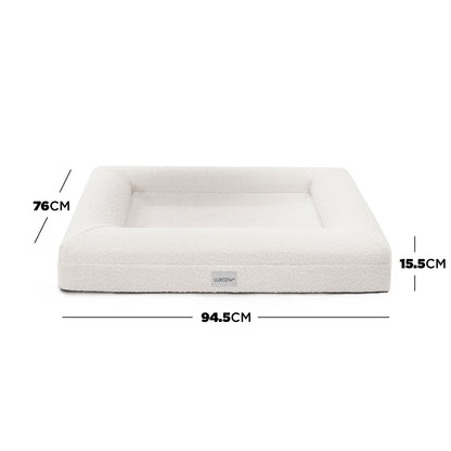 Tyro Luxe Medium Orthopedic Pet Bed – Light Beige; close-up of a plush, textured surface with a subtle logo, highlighting its supportive structure and premium fabric designed for pet comfort.