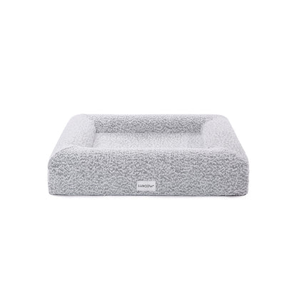 Tyro Luxe Small Orthopedic Pet Bed – Black & White, featuring a close-up of its soft boucle fabric and high-density memory foam base, designed for joint support and modern home aesthetics.