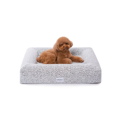 Tyro Luxe Small Orthopedic Pet Bed – Black & White, featuring a dog lying comfortably on the soft boucle surface, highlighting the bed's ergonomic design and supportive high-density memory foam for small pets.