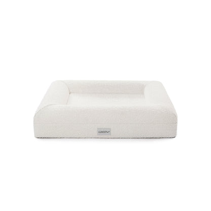 Tyro Luxe Small Orthopedic Pet Bed with dual-layer memory foam, boucle cover, and anti-slip base, designed for small pets. Showcased in a simple, elegant setting with a white background.