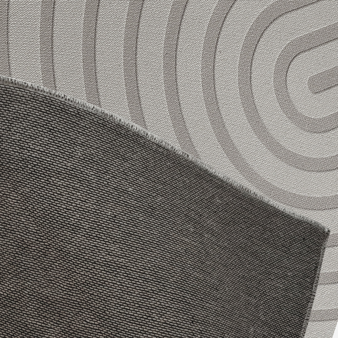 Close-up of Alfy 200x300cm Large Tufted Modern Abstract Indoor Rug, showcasing dark gray overlocked edge atop a light mat with broad concentric rings, emphasizing its modern, luxurious design.