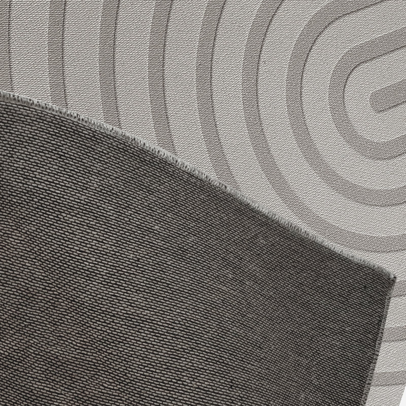 Close-up of Alfy 200x300cm Large Tufted Modern Abstract Indoor Rug, showcasing dark gray overlocked edge atop a light mat with broad concentric rings, emphasizing its modern, luxurious design.