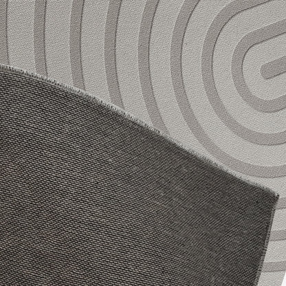 Close-up of Alfy 200x300cm Large Tufted Modern Abstract Indoor Rug, showcasing dark gray overlocked edge atop a light mat with broad concentric rings, emphasizing its modern, luxurious design.