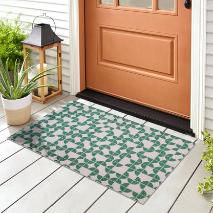 Angell 60x90cm Modern Outdoor Floor Doormat in Teal, featuring a geometric leaf pattern, placed on a painted porch floor, surrounded by a potted succulent and a wooden lantern with a candle.