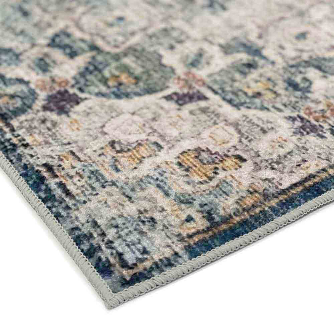 Close-up of Ariza 120x170cm Small Persian Silky Indoor Floor Rug, showcasing its stitched edge and vintage-style geometric pattern in muted tones, highlighting its soft, low-maintenance qualities.