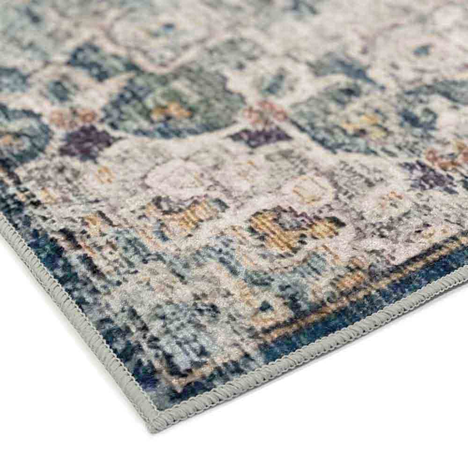 Close-up of the Ariza 160x230cm Medium Persian Silky Indoor Floor Rug, showcasing its intricate beige floral pattern on a dark green base, with a slightly distressed design and stitched binding.