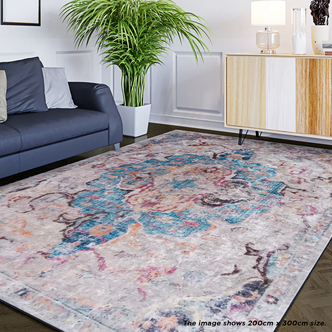 Arwani 200x300 cm rug with a soft, vintage-inspired pattern of muted pastels and distressed Persian design, enhancing a styled living room corner with a dark parquet floor and modern decor.
