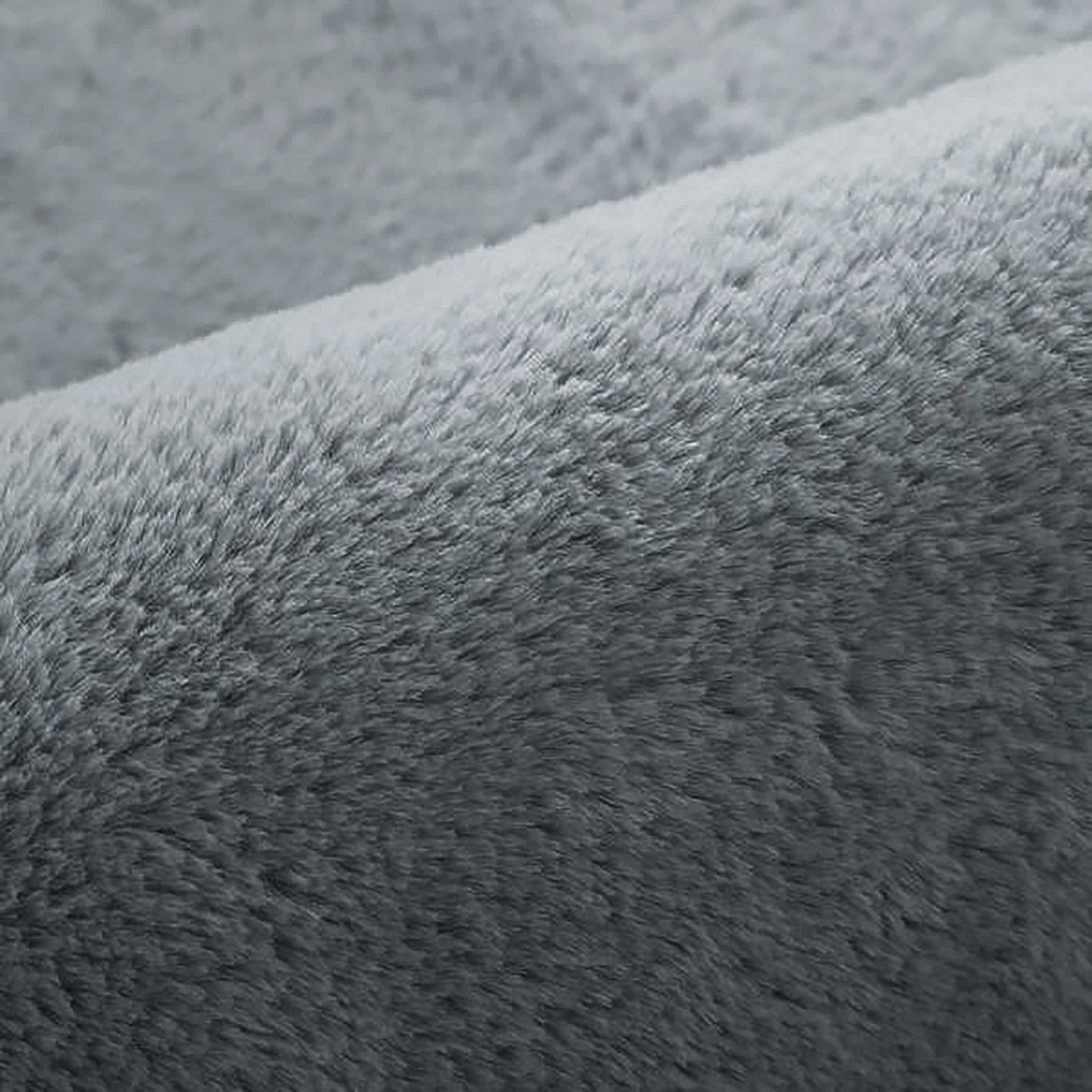 Close-up of Azaliya Dark Grey Round Faux Rabbit Fur Rug 160cm, showcasing its plush, fuzzy texture with visible folds, illustrating the soft, luxurious nap of the faux rabbit fur material.