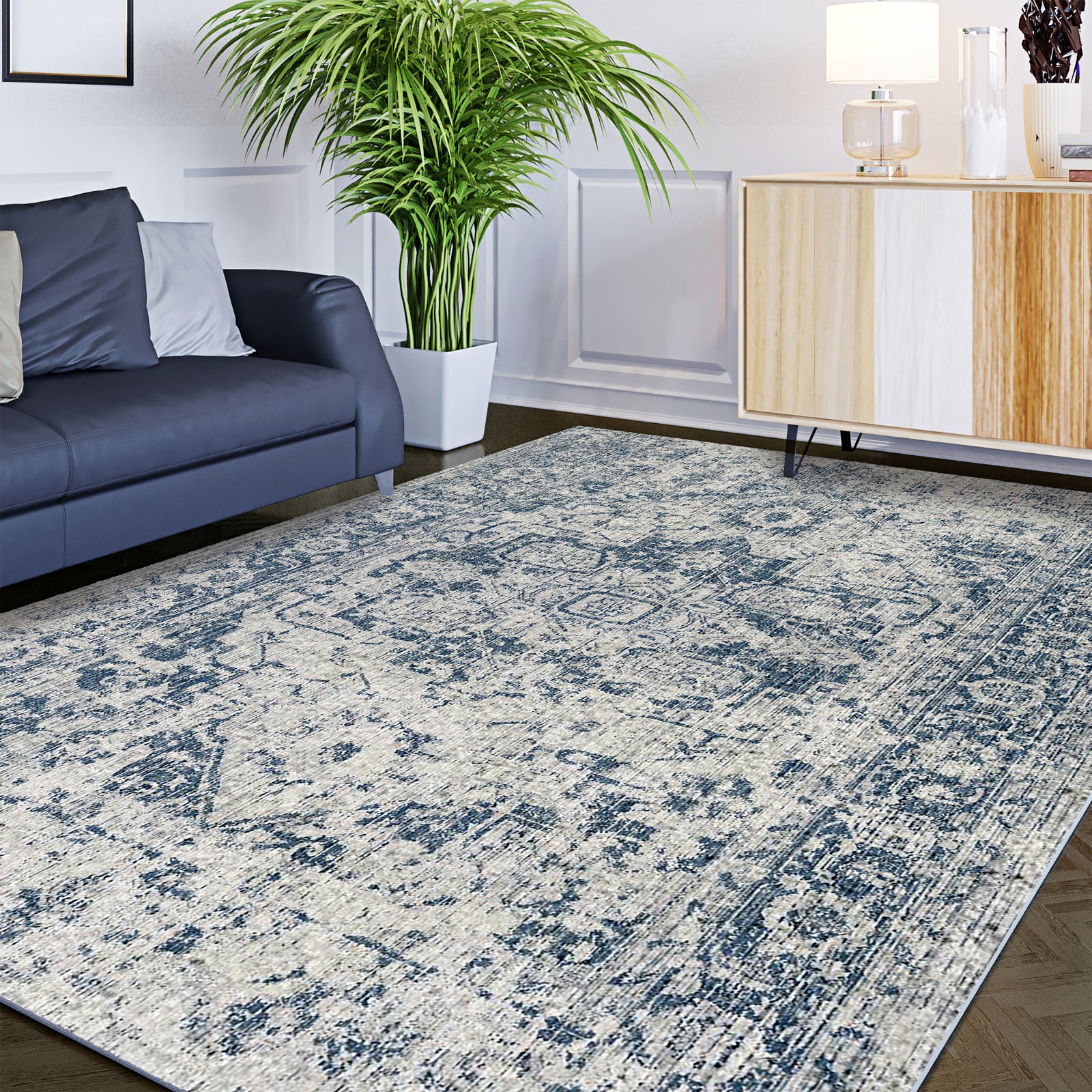 Boda 200x300cm Distressed Persian Silky Indoor Floor Rug with vintage cream and blue pattern on dark wood floor, near a navy sofa and midcentury sideboard, enhancing the cozy living-room ambiance.