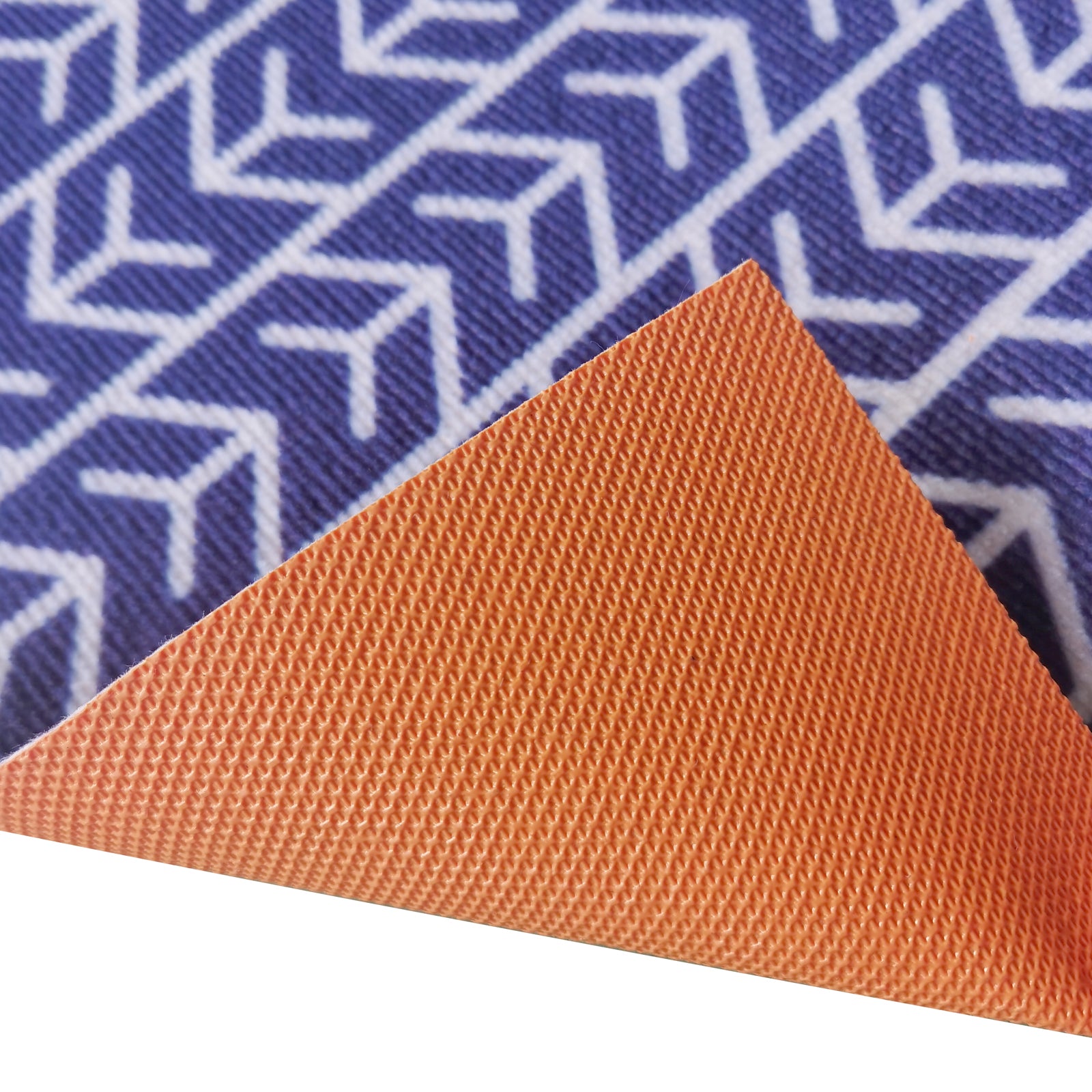 Close-up of Carey 45x75cm Outdoor Doormat in White & Indigo, showing the textured orange side lifted to reveal a blue-and-white geometric pattern underneath, highlighting its abstract design and durability.