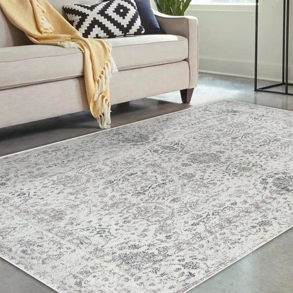 Cesco 160x230cm Polyester Persian Printed Indoor Floor Rug with a subtly distressed pattern, placed in a modern living room setting with a beige sofa, mustard throw, and geometric pillow.