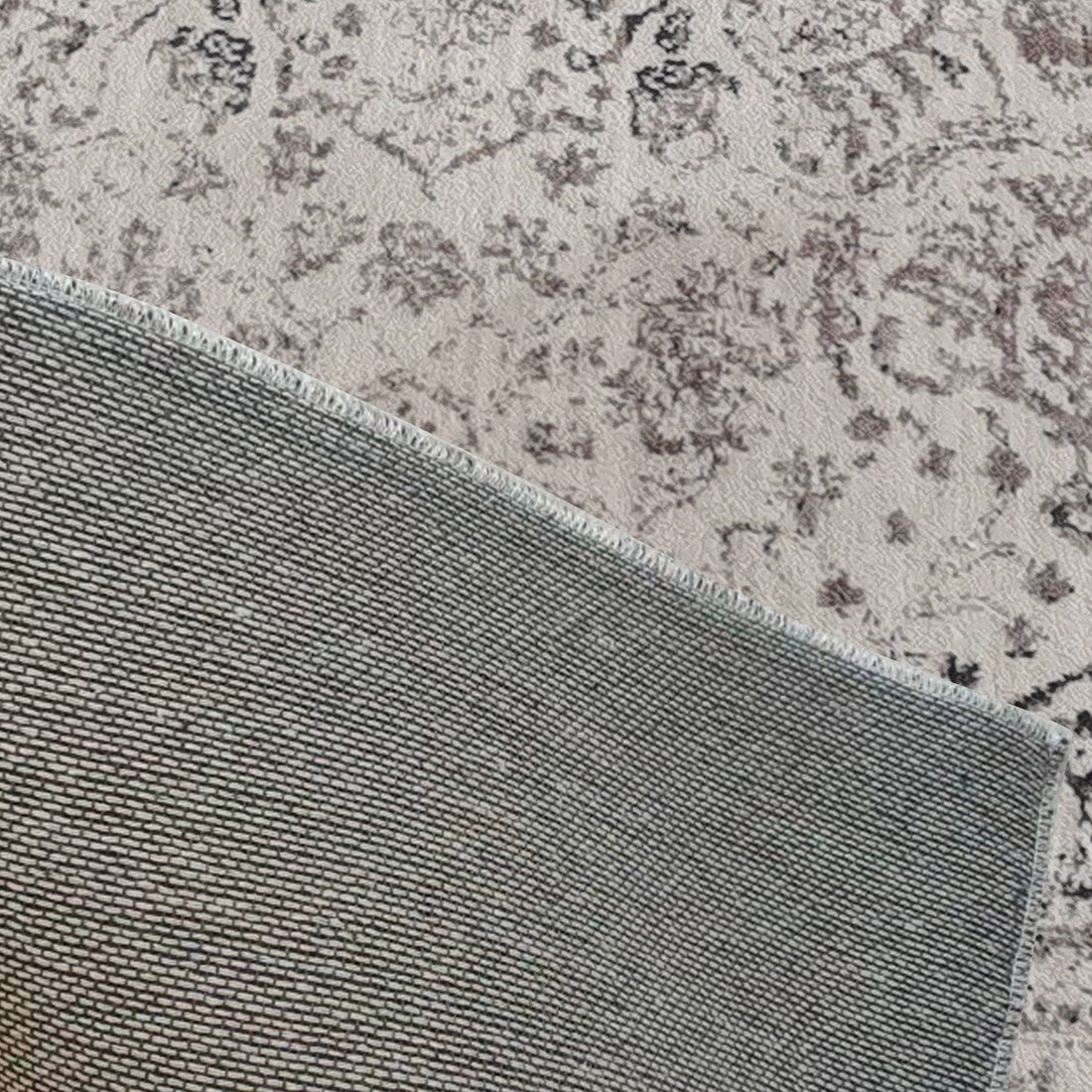 Corner of Cesco 200x300cm Polyester Persian Printed Indoor Floor Rug flipped up, revealing woven backing and light-colored abstract pattern beneath, highlighting intricate Persian design and plush texture.