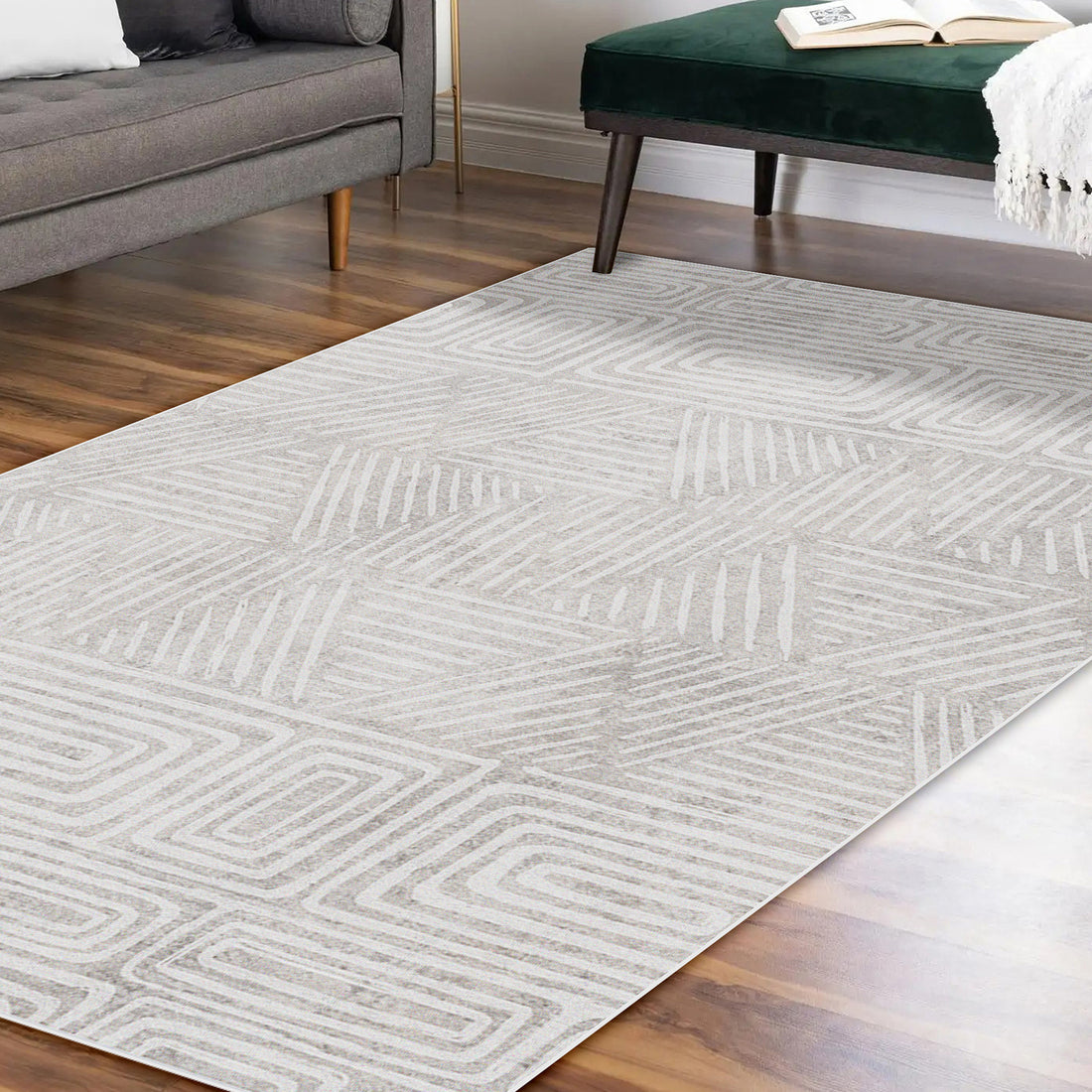 Duved 120x180cm Small Contemporary Indoor Floor Rug with geometric pattern, showcased on hardwood flooring, accompanied by a mid-century gray sofa and dark green velvet bench, highlighting modern decor.