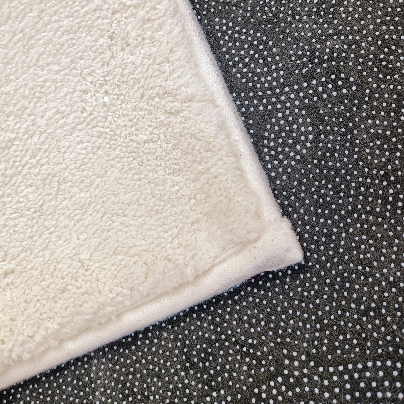 Evane 120x180cm Kids Cloud Modern Indoor Floor Rug showcasing white plush-pile fabric atop dark rubberized non-slip backing with white grip dots, designed for children's room comfort and safety.