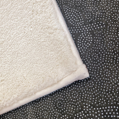 Evane 120x180cm Kids Cloud Modern Indoor Floor Rug showcasing white plush-pile fabric atop dark rubberized non-slip backing with white grip dots, designed for children's room comfort and safety.