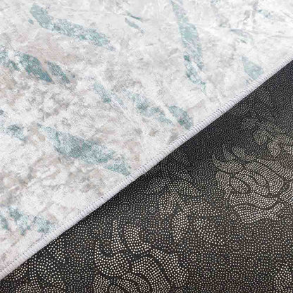 Close-up of the Foldvik Art Contemporary Rug 120x170cm, showcasing its intricate tribal-inspired pattern in greens and creams, highlighting the rug's soft texture and durable woven polyester construction.