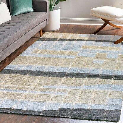 Isaac 120x180cm Abstract Wool Blend Handwoven Shag Rug featuring a plush block-pattern design on a dark hardwood floor, complementing the mid-century sofa and cushioned bench.