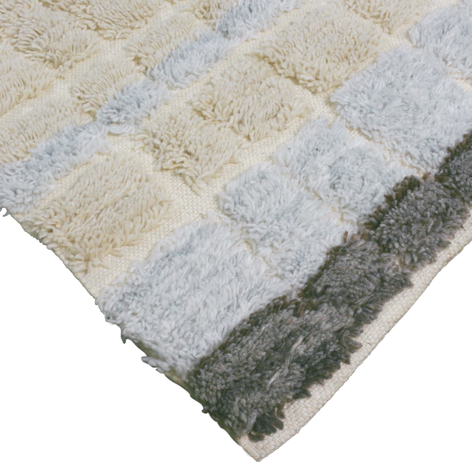 Close-up of Isaac Wool Blend Handwoven Shag Rug 120x180cm, featuring tufted, plush squares in a checkerboard layout with a textured, shaggy surface in neutral tones and darker charcoal gray border.