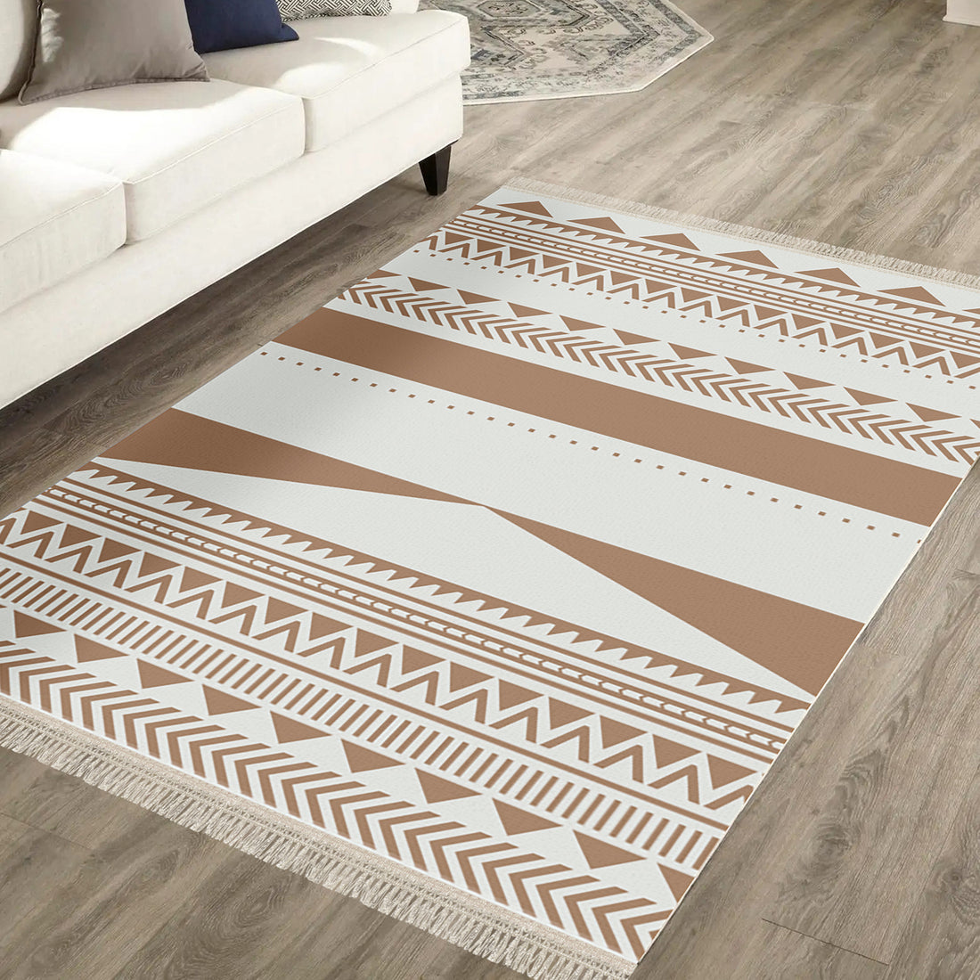Kaley 200x300cm Woven Cotton Blend Tasseled Indoor Rug on light-wood floor, featuring cream and tan geometric tribal motifs with short fringe, under a white sofa.