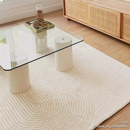 Krokom 160x230cm Modern Abstract Indoor Floor Rug under a glass-top coffee table, showcasing a subtle concentric-circle pattern, complementing a minimalist living room with light oak hardwood flooring.