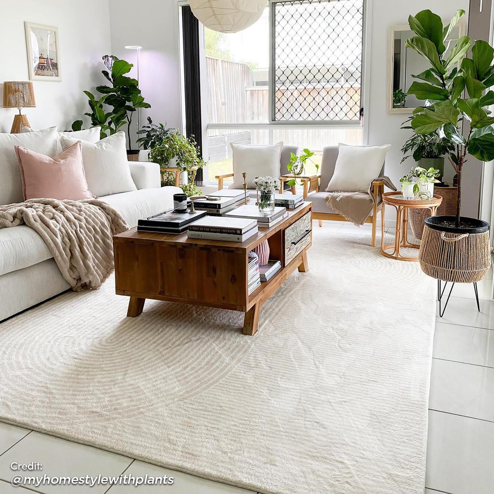 Krokom 200x300cm Modern Abstract Indoor Floor Rug lies under a central wooden coffee table, featuring a subtle arc pattern, enhancing the cozy Scandinavian-inspired living room with its chic, contemporary design.