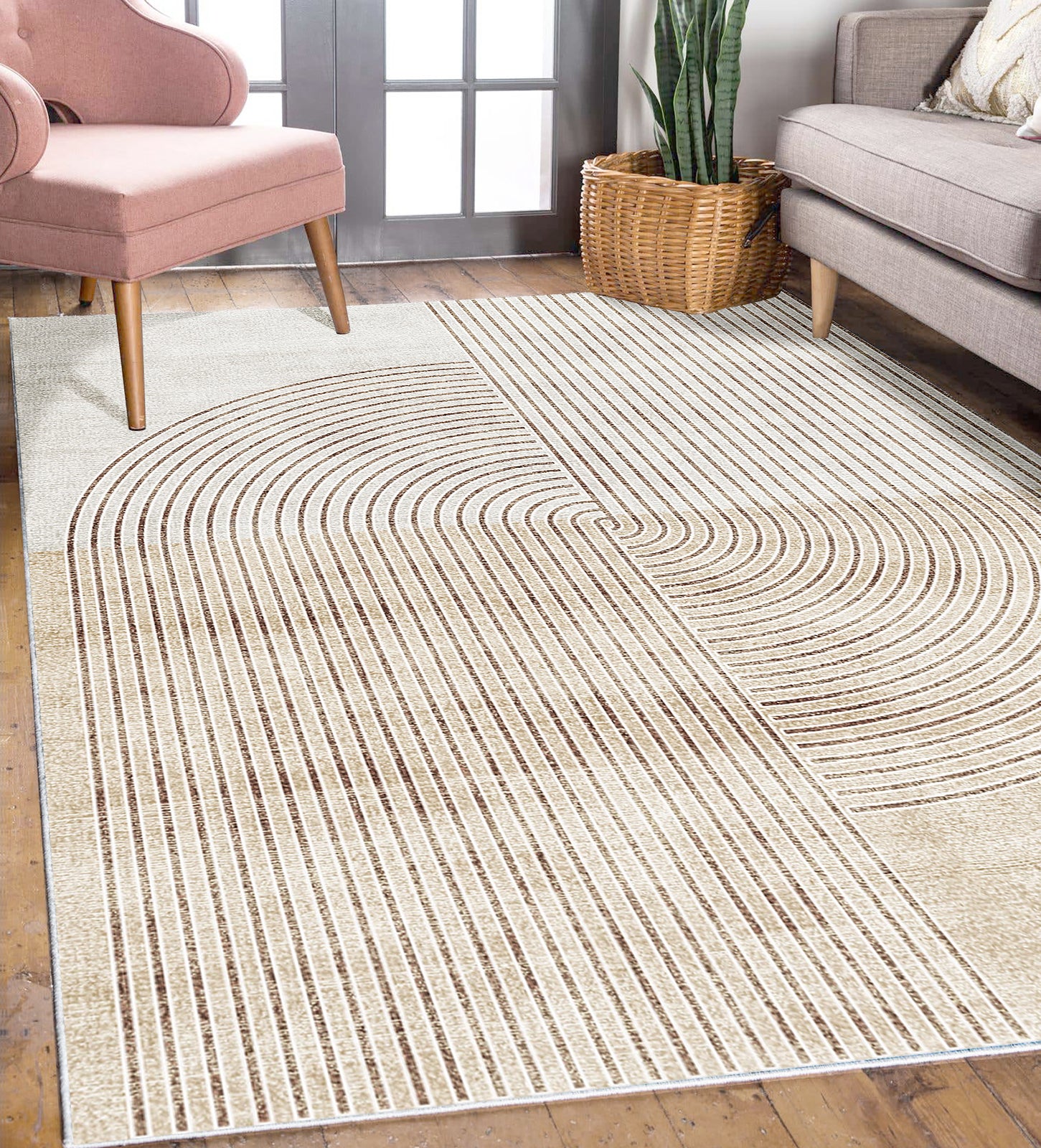 Lunder 160x230cm Modern Abstract Floor Rug in creamy-neutral tones with soft brown concentric-arch lines, placed on warm hardwood flooring, enhancing a mid-century-inspired living room with a blush chair and light-gray sofa.