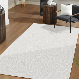 Malung 120x180cm Contemporary Indoor Floor Rug on wood floor, featuring a subtle abstract linear pattern, complements the modern armchair and side tables, creating a clean, contemporary setting.