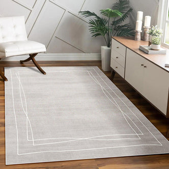 Manstad 160x230cm Modern Indoor Floor Rug on wood flooring, featuring a subtle texture and white double-border pattern, with a mid-century chair and console table, creating a stylish, cosy living area.