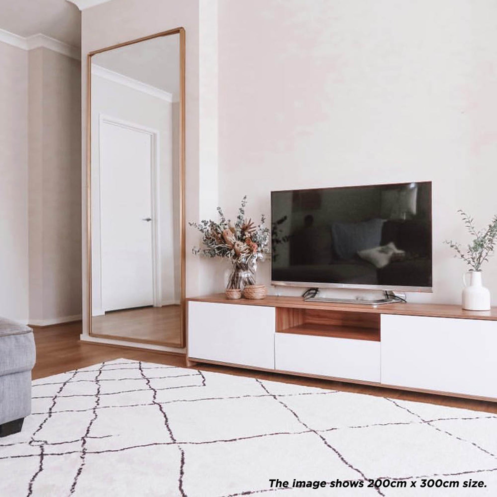 Melody Black & White Modern Rug 120x170cm features abstract black lines on an ivory backdrop, ideal for contemporary interiors. Suitable for high-traffic areas, offering durability and a Scandinavian-inspired design.