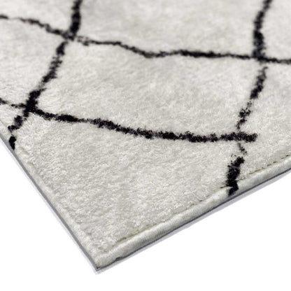 Close-up of Melody Black & White Modern Rug 120x170cm, showcasing its Scandinavian-inspired design with abstract black lines on an ivory backdrop, highlighting the rug's soft texture and durable poly-cotton backing.