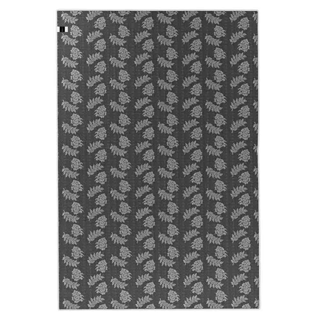 Melody Black and White Modern Floor Rug 200 x 300cm features a repeating botanical motif with light-gray leaf clusters on a dark gray background, ideal for adding style to high-traffic areas.