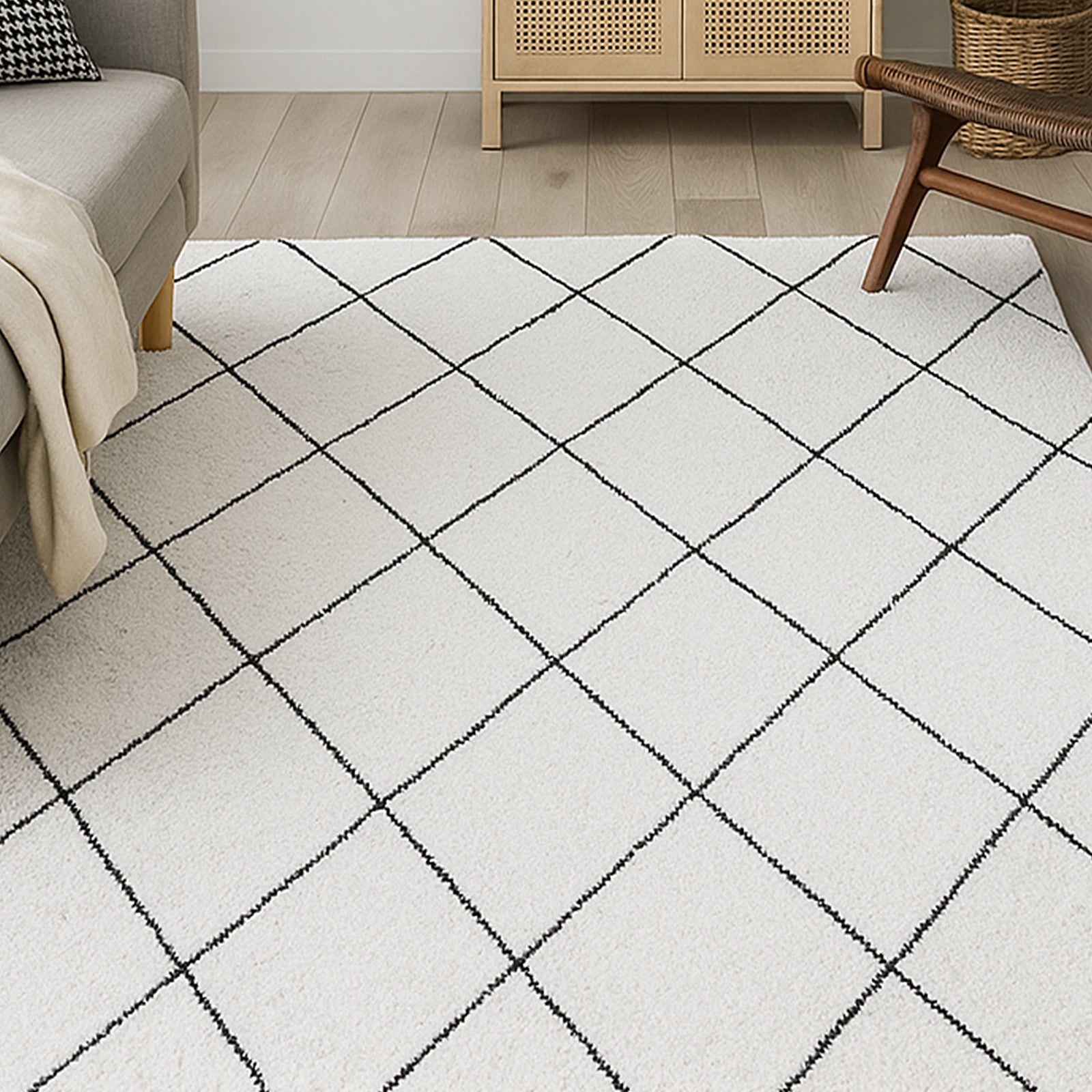 Milani 200x300cm Contemporary Printed Indoor Floor Rug features an off-white base with a black diamond pattern, enhancing a modern-Scandi vibe in a cozy living space with light wood flooring.