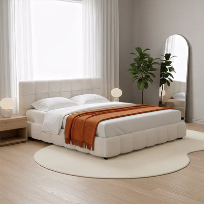 Parna 200 x 300cm Curved Soft Rug in Cream White lies beneath the bed, showcasing its plush, sculptural design amidst a cozy bedroom setting with a modern, minimalist aesthetic.